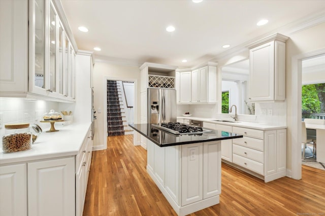 39 Gatewood Unit 39, Avon, CT 06001 - kitchen featuring stainless steel appliances, plenty of natural light, light wood-style floors, white cabinets, and ornamental molding