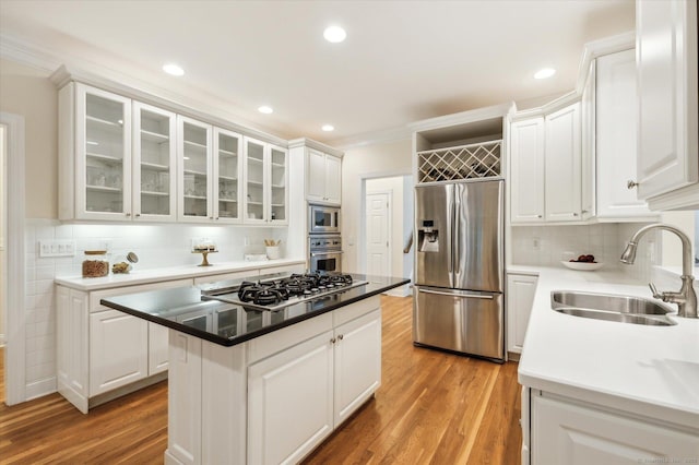 39 Gatewood Unit 39, Avon, CT 06001 - kitchen with built in appliances, a sink, white cabinets, light wood-type flooring, and crown molding