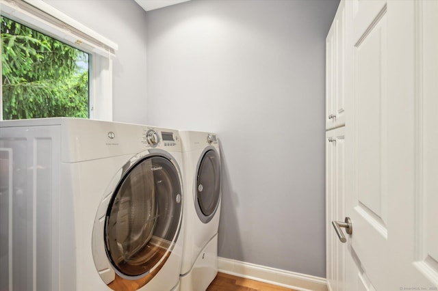 39 Gatewood Unit 39, Avon, CT 06001 - laundry area featuring washer and dryer, cabinet space, baseboards, and wood finished floors