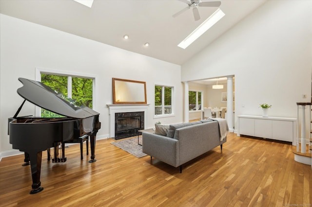 39 Gatewood Unit 39, Avon, CT 06001 - living room with plenty of natural light, high vaulted ceiling, a skylight, a premium fireplace, and light wood finished floors