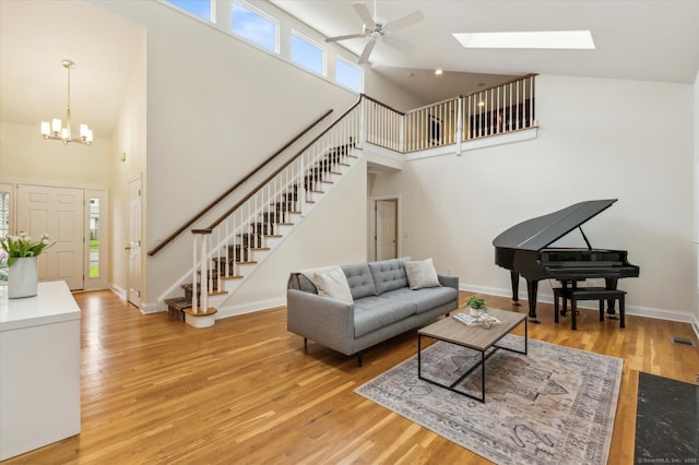 39 Gatewood Unit 39, Avon, CT 06001 - living room with stairway, a towering ceiling, wood finished floors, a ceiling fan, and healthy amount of natural light