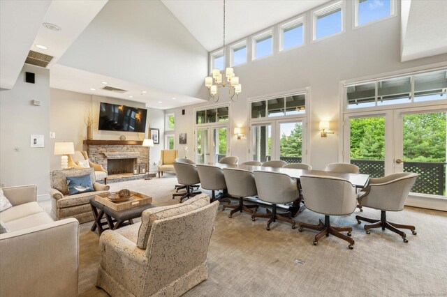39 Gatewood Unit 39, Avon, CT 06001 - living room with french doors, a high ceiling, a fireplace, a chandelier, and recessed lighting