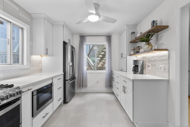 2 Mansfield Grove Rd Apt 166, East Haven, CT 06512 - kitchen featuring appliances with stainless steel finishes, open shelves, backsplash, light countertops, and ceiling fan