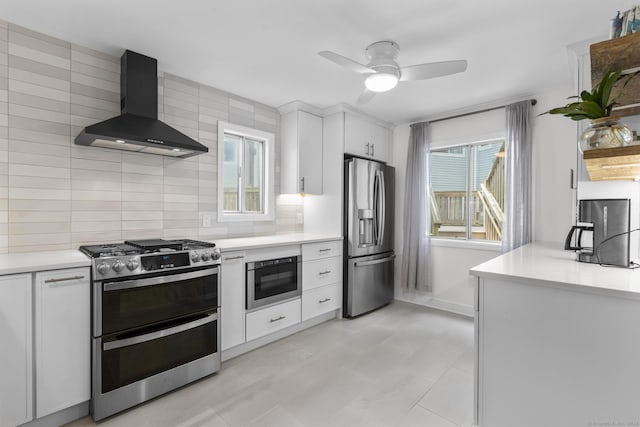 2 Mansfield Grove Rd Apt 166, East Haven, CT 06512 - kitchen with wall chimney range hood, stainless steel appliances, white cabinets, and plenty of natural light