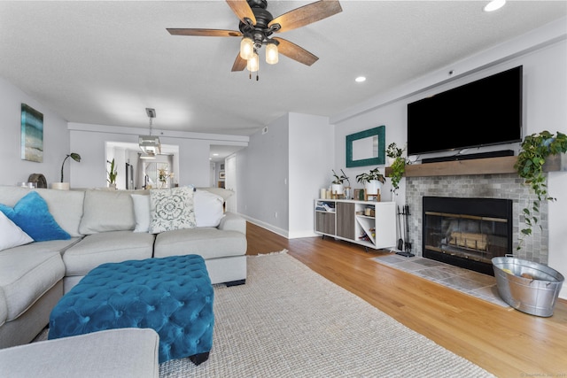 2 Mansfield Grove Rd Apt 166, East Haven, CT 06512 - living area with wood finished floors, a ceiling fan, a tile fireplace, recessed lighting, and baseboards