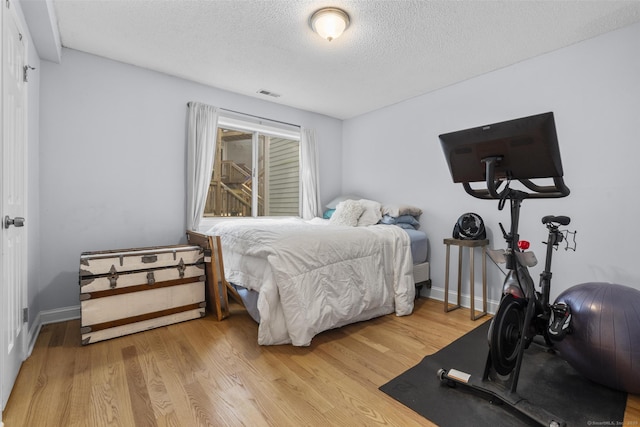 2 Mansfield Grove Rd Apt 166, East Haven, CT 06512 - bedroom with light wood finished floors, a textured ceiling, and baseboards