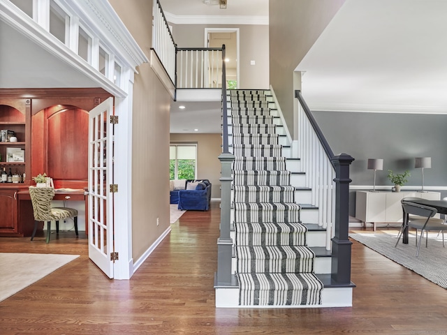 10 Wilton Hunt Rd, Wilton, CT 06897 - staircase with crown molding, wood finished floors, baseboards, and a high ceiling