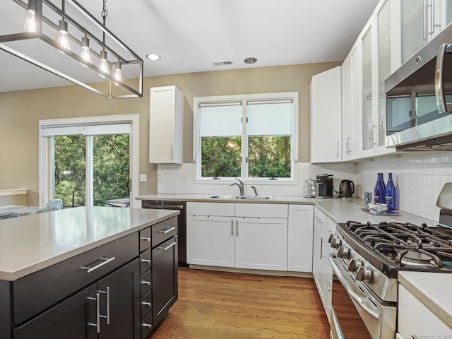 10 Wilton Hunt Rd, Wilton, CT 06897 - kitchen with stainless steel appliances, a sink, white cabinets, light countertops, and recessed lighting