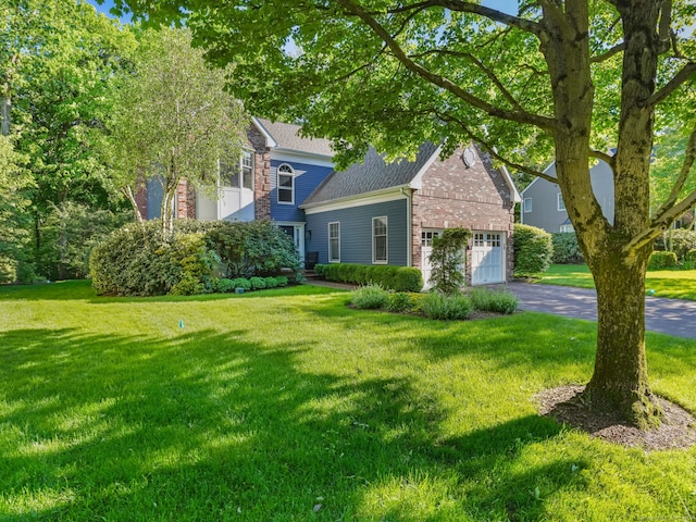 10 Wilton Hunt Rd, Wilton, CT 06897 - obstructed view of property with driveway, a front lawn, and an attached garage