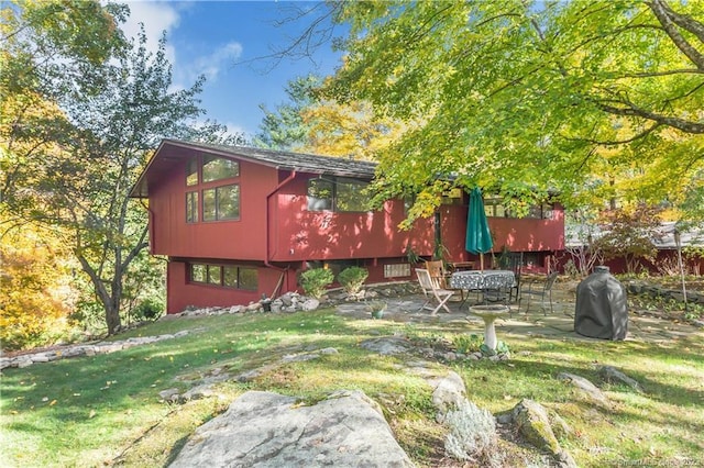 235 Whipstick Rd, Wilton, CT 06897 - back of property featuring a lawn and a patio