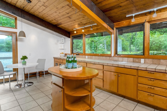 235 Whipstick Rd, Wilton, CT 06897 - kitchen featuring track lighting, open shelves, wood ceiling, light tile patterned flooring, and plenty of natural light