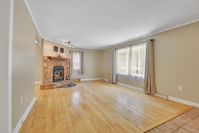 31 Hemlock Dr, Southington, CT 06489 - unfurnished living room with ornamental molding, baseboards, wood finished floors, and a stone fireplace