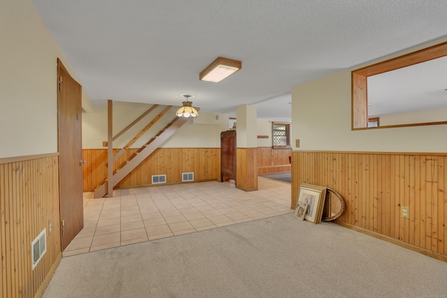 31 Hemlock Dr, Southington, CT 06489 - additional living space featuring wainscoting, wood walls, stairs, light colored carpet, and light tile patterned floors