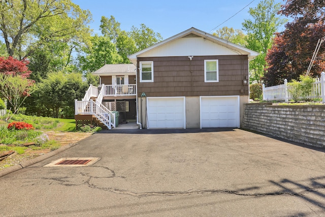 31 Hemlock Dr, Southington, CT 06489 - rear view of property featuring stairway, asphalt driveway, a garage, and a porch