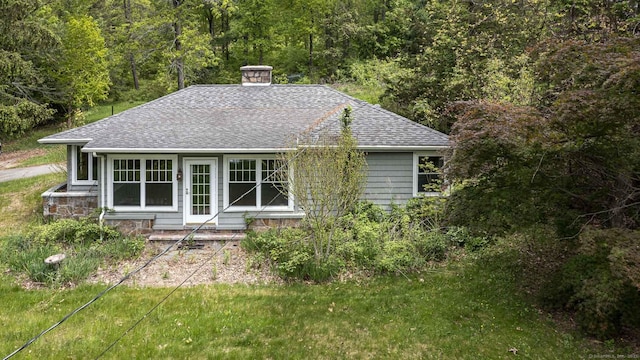 179 Parker Rd, Somers, CT 06071 - back of property featuring roof with shingles, a forest view, and a chimney