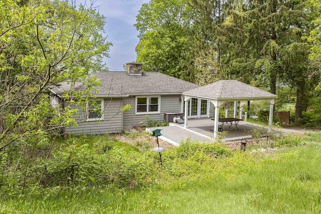 179 Parker Rd, Somers, CT 06071 - rear view of property with a chimney, a gazebo, a patio, and roof with shingles