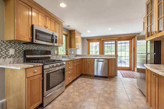 179 Parker Rd, Somers, CT 06071 - kitchen with appliances with stainless steel finishes, a peninsula, decorative backsplash, a sink, and glass insert cabinets