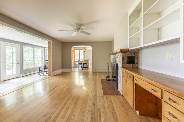 179 Parker Rd, Somers, CT 06071 - kitchen with a baseboard heating unit, ceiling fan, arched walkways, and light wood-style flooring