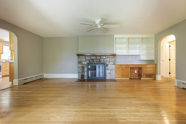 179 Parker Rd, Somers, CT 06071 - unfurnished living room with a baseboard heating unit, a ceiling fan, arched walkways, and light wood-style floors