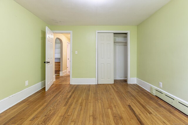179 Parker Rd, Somers, CT 06071 - unfurnished bedroom featuring light wood-style flooring, baseboards, a baseboard heating unit, and a closet