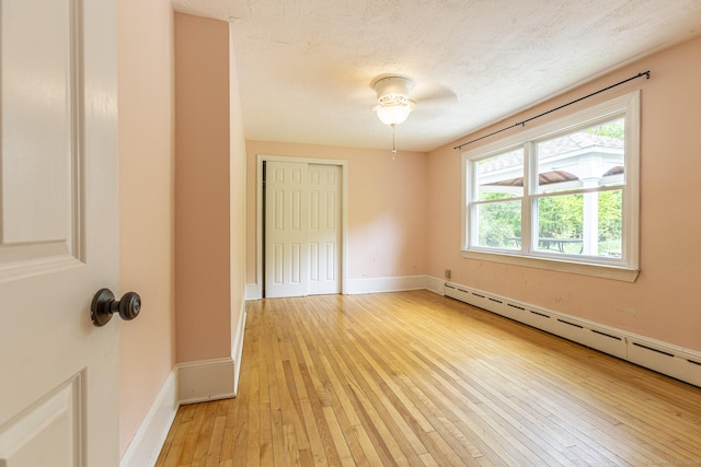 179 Parker Rd, Somers, CT 06071 - spare room with baseboard heating, light wood-style floors, and baseboards
