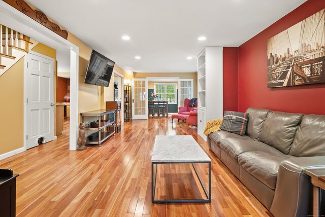 28 Edmund St, Stratford, CT 06614 - living room featuring light wood-style floors, stairway, recessed lighting, french doors, and baseboards