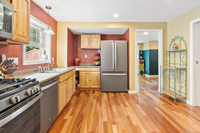 28 Edmund St, Stratford, CT 06614 - kitchen with stainless steel appliances, a sink, light wood finished floors, light countertops, and pendant lighting