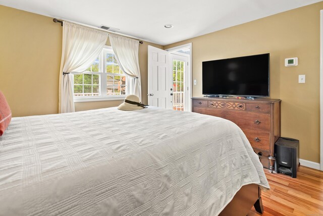 28 Edmund St, Stratford, CT 06614 - bedroom featuring wood finished floors, baseboards, recessed lighting, and access to exterior