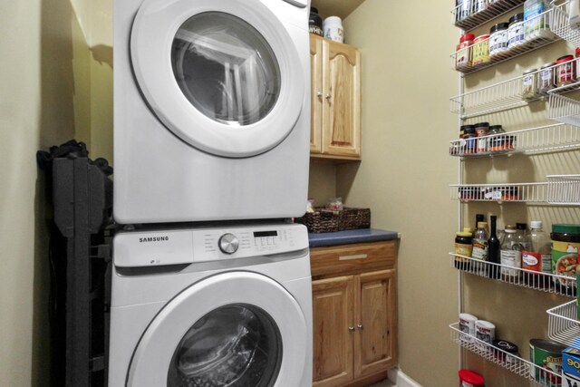 28 Edmund St, Stratford, CT 06614 - washroom with stacked washer / drying machine and cabinet space