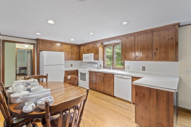 8 Michael Rd, Simsbury, CT 06070 - kitchen featuring white appliances, recessed lighting, light wood finished floors, light countertops, and brown cabinets