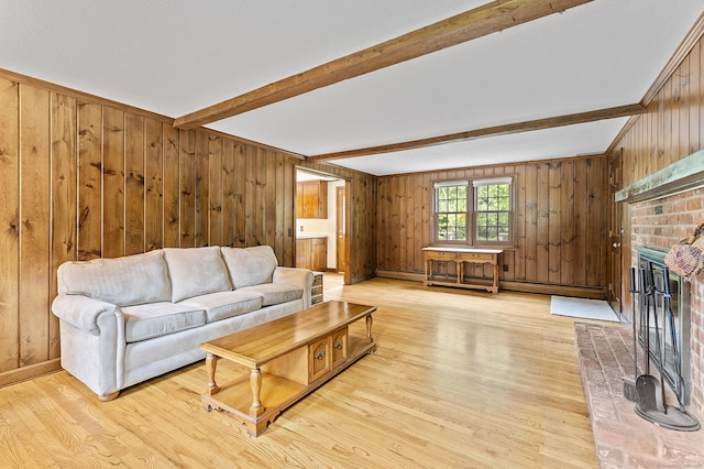 8 Michael Rd, Simsbury, CT 06070 - living room with beamed ceiling, wood walls, a fireplace, light wood-style floors, and a baseboard radiator