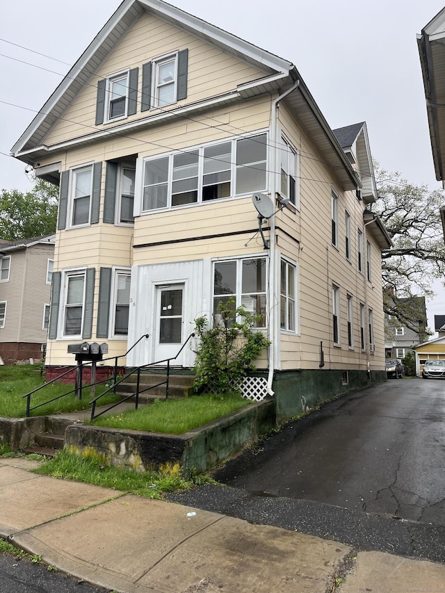 56 N First St, Meriden, CT 06451 - view of front facade with a fenced front yard and entry steps