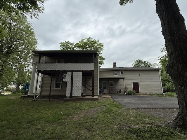 131 W Main St, Southington, CT 06479 - back of house with a chimney, a lawn, driveway, and a patio area