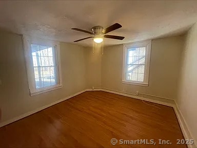 131 W Main St, Southington, CT 06479 - empty room featuring baseboards, wood finished floors, and ceiling fan