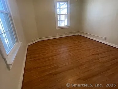 131 W Main St, Southington, CT 06479 - empty room with dark wood-type flooring and baseboards
