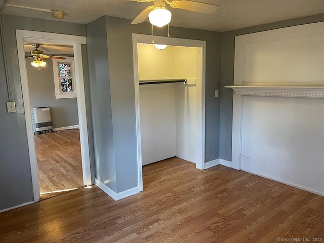 131 W Main St, Southington, CT 06479 - unfurnished bedroom with wood finished floors, a closet, baseboards, and ceiling fan