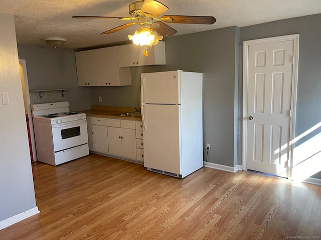 131 W Main St, Southington, CT 06479 - kitchen featuring white appliances, light wood finished floors, a textured ceiling, ceiling fan, and white cabinetry