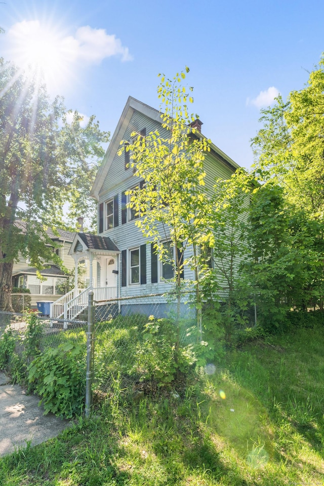 38 Ford St, New Haven, CT 06511 - view of front of home with a chimney and fence