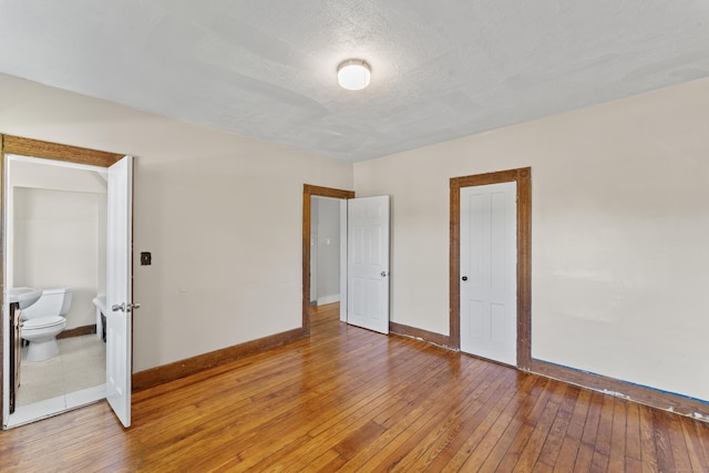 38 Ford St, New Haven, CT 06511 - empty room featuring baseboards, light wood-style floors, and a textured ceiling