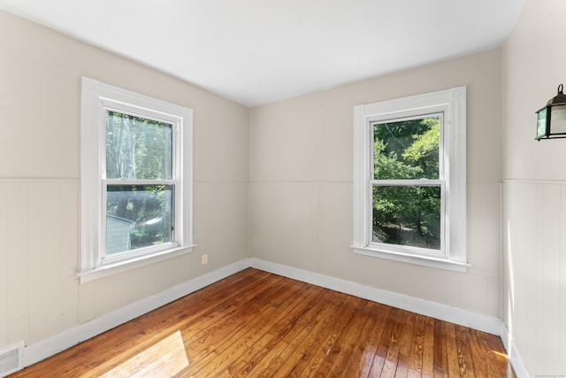 38 Ford St, New Haven, CT 06511 - spare room featuring hardwood / wood-style flooring, healthy amount of natural light, wainscoting, and baseboards
