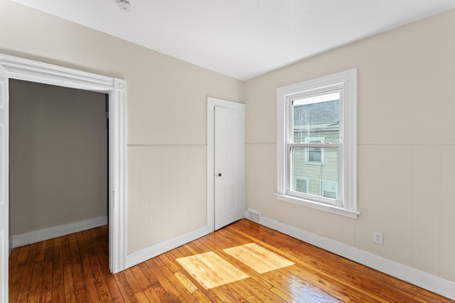 38 Ford St, New Haven, CT 06511 - unfurnished bedroom featuring hardwood / wood-style flooring, wainscoting, and baseboards