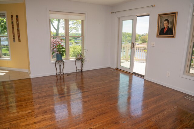 58 Quarry Dock Rd Unit 58, Branford, CT 06405 - unfurnished room featuring healthy amount of natural light, wood finished floors, and baseboards