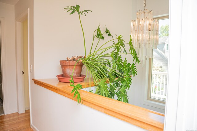 58 Quarry Dock Rd Unit 58, Branford, CT 06405 - corridor featuring a chandelier, light wood-style floors, and baseboards