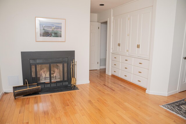 58 Quarry Dock Rd Unit 58, Branford, CT 06405 - detailed view of wood finished floors, baseboards, and a fireplace with flush hearth