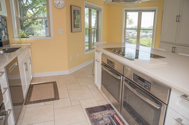 58 Quarry Dock Rd Unit 58, Branford, CT 06405 - kitchen featuring stainless steel oven, black electric stovetop, baseboards, and plenty of natural light