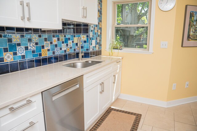 58 Quarry Dock Rd Unit 58, Branford, CT 06405 - kitchen with stainless steel dishwasher, baseboards, tasteful backsplash, a sink, and white cabinetry