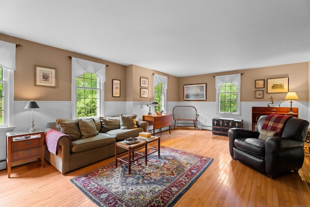 57 Elm Ridge Rd, Stonington, CT 06379 - living area with a wainscoted wall, healthy amount of natural light, light wood-style flooring, baseboard heating, and a baseboard radiator