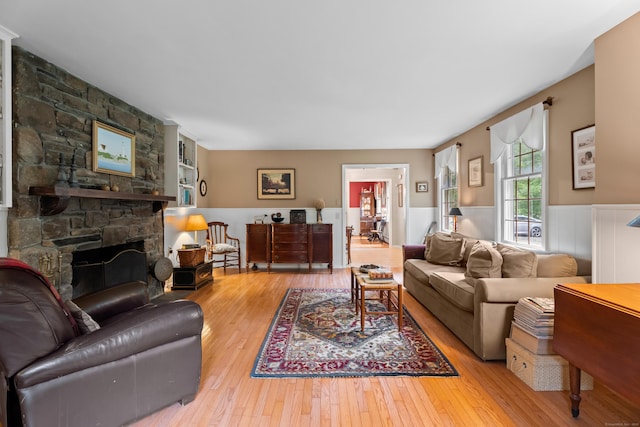 57 Elm Ridge Rd, Stonington, CT 06379 - living room with a wainscoted wall, hardwood / wood-style flooring, and a stone fireplace