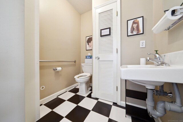189 E Ave, Norwalk, CT 06855 - half bath featuring tile patterned floors, toilet, and baseboards
