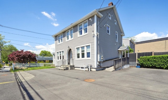 189 E Ave, Norwalk, CT 06855 - rear view of house with a chimney and asphalt driveway